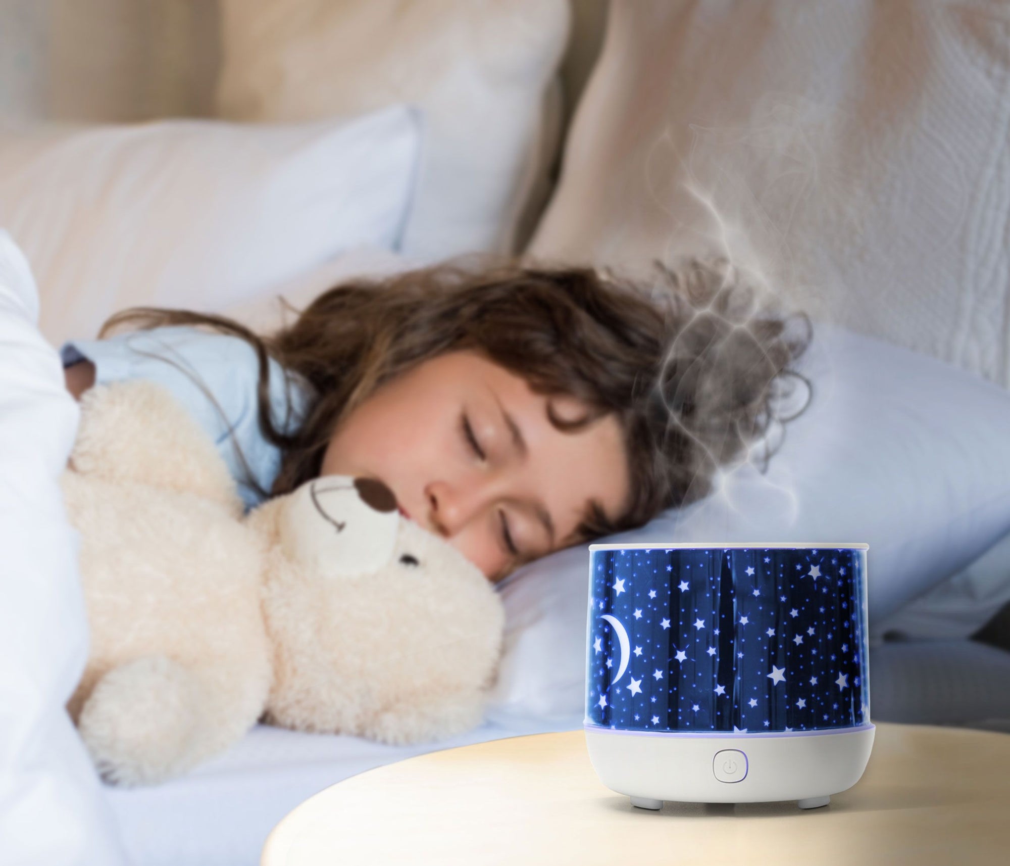 aromatherapy diffuser on bedside table with child sleeping