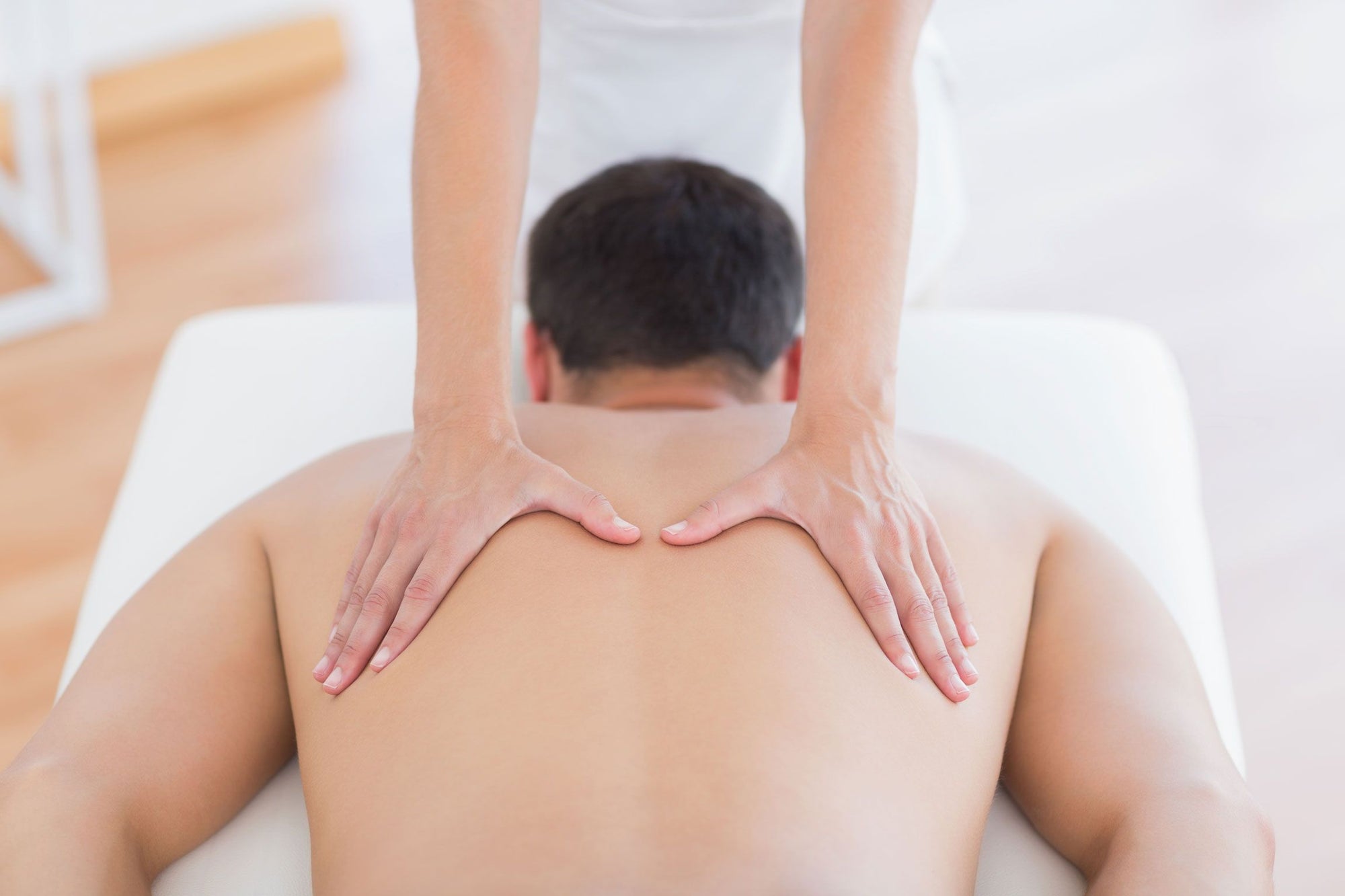 Person being massaged on a massage table