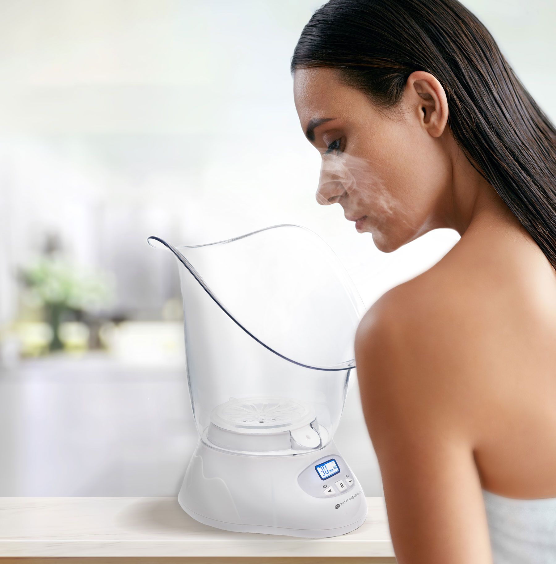 Woman leaning over a facial sauna with steam rising