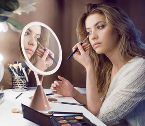 lady using HD illuminated make up mirror on dressing table with HD light illuminated to apply make up