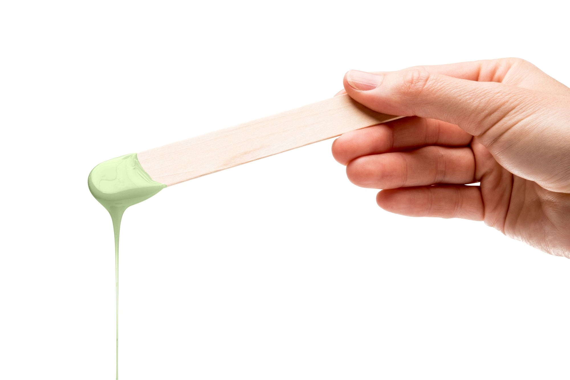 melted green tea wax dripping off spatula 