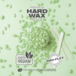 Green tea premium hard wax beads laid out with spatulas labelled 100% vegan and professional pro-flex wax