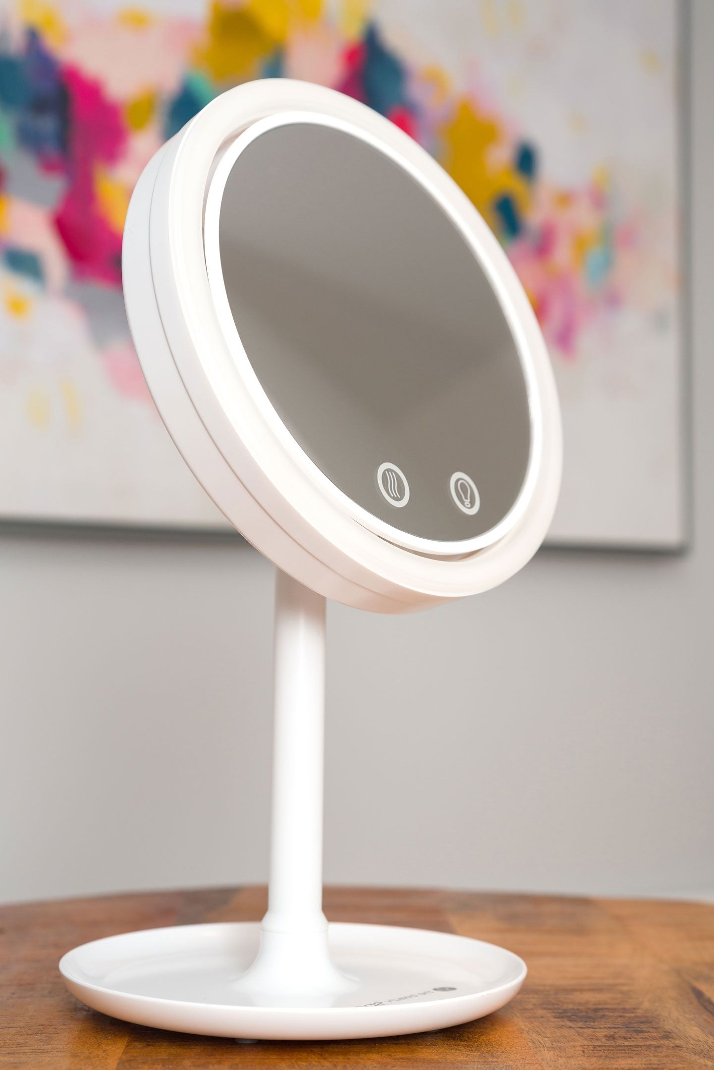 keep cool mirror with fan and LED light ring on wooden table in a home setting with LED ring light illuminated 