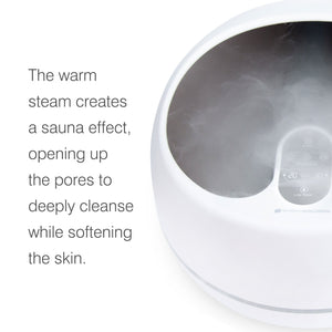 steam foot spa with steam on captioned 'the warm steam creates a sauna effect, opening up the pores to deeply cleanse while softening the skin'