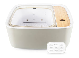 Scandinavian jacuzzi foot spa with hand held controls laid in front