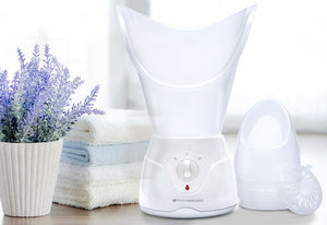 Facial sauna with steam inhaler attachment and oil vaporiser in spa like setting with fresh folded towels and potted lavender