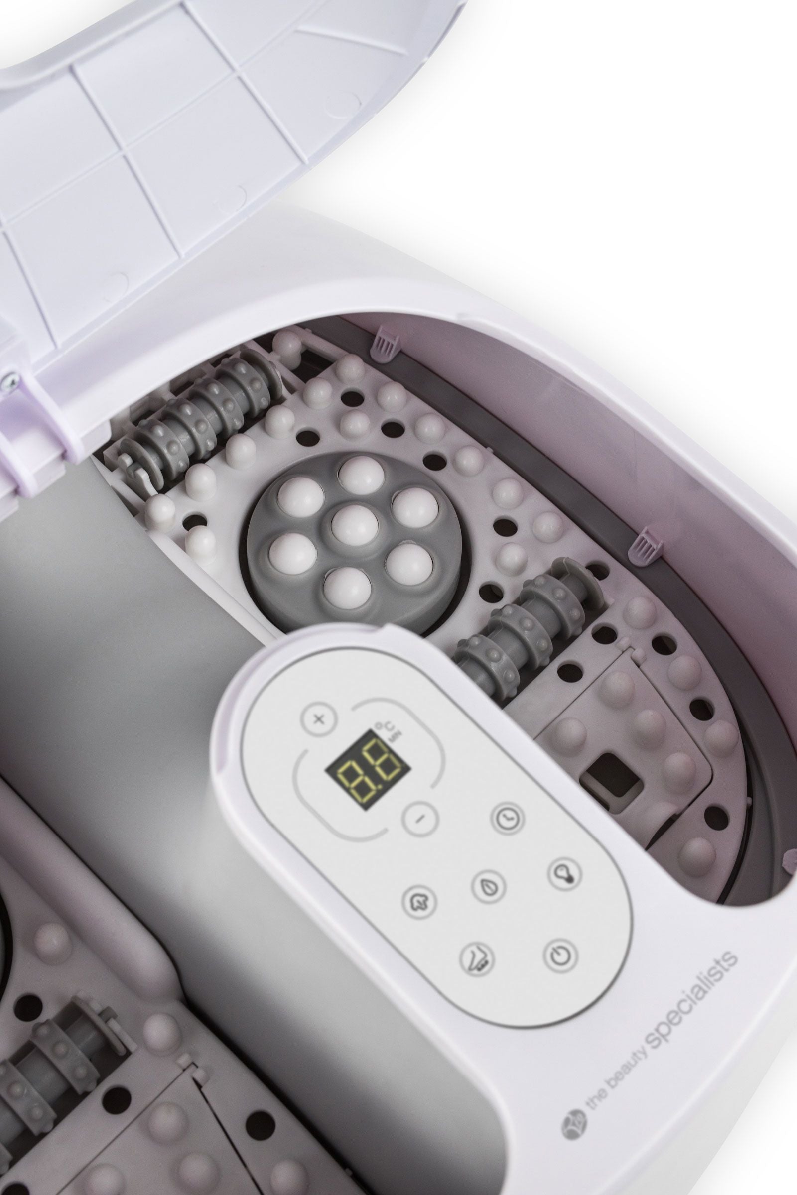 close up of pebble base and massage rollers inside deluxe steam foot spa 