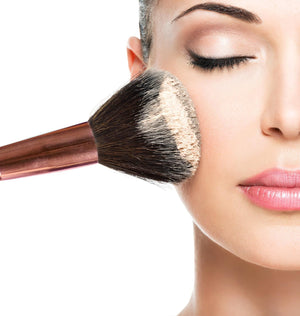 Ladies face using large powder brush to apply setting powder to skin 