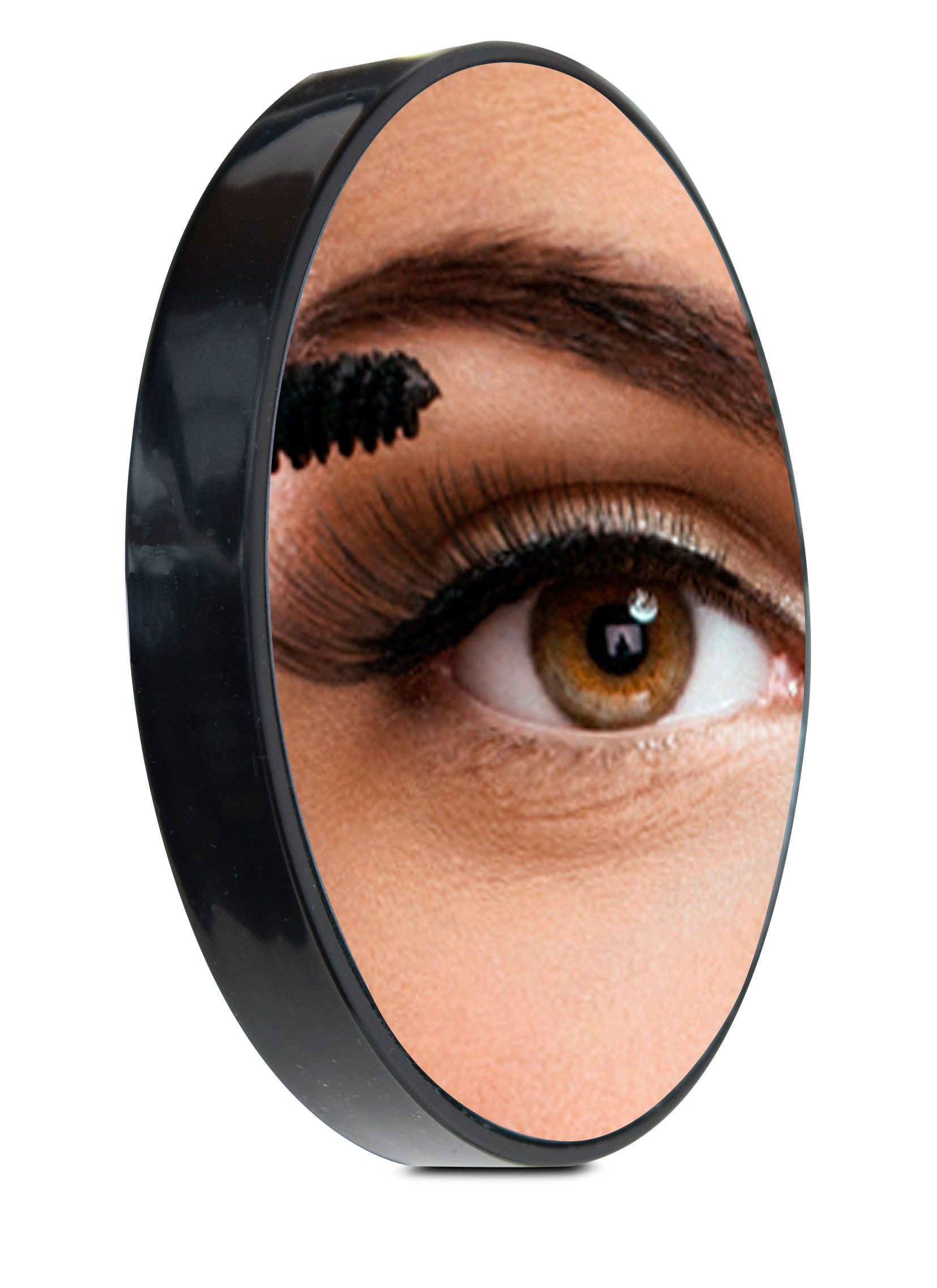 compact 10x magnification mirror with reflection of ladies eye applying mascara