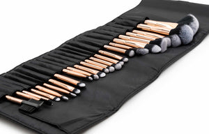 angled view of lush rose gold 24 piece make up brush collection laid out in classy travel pouch